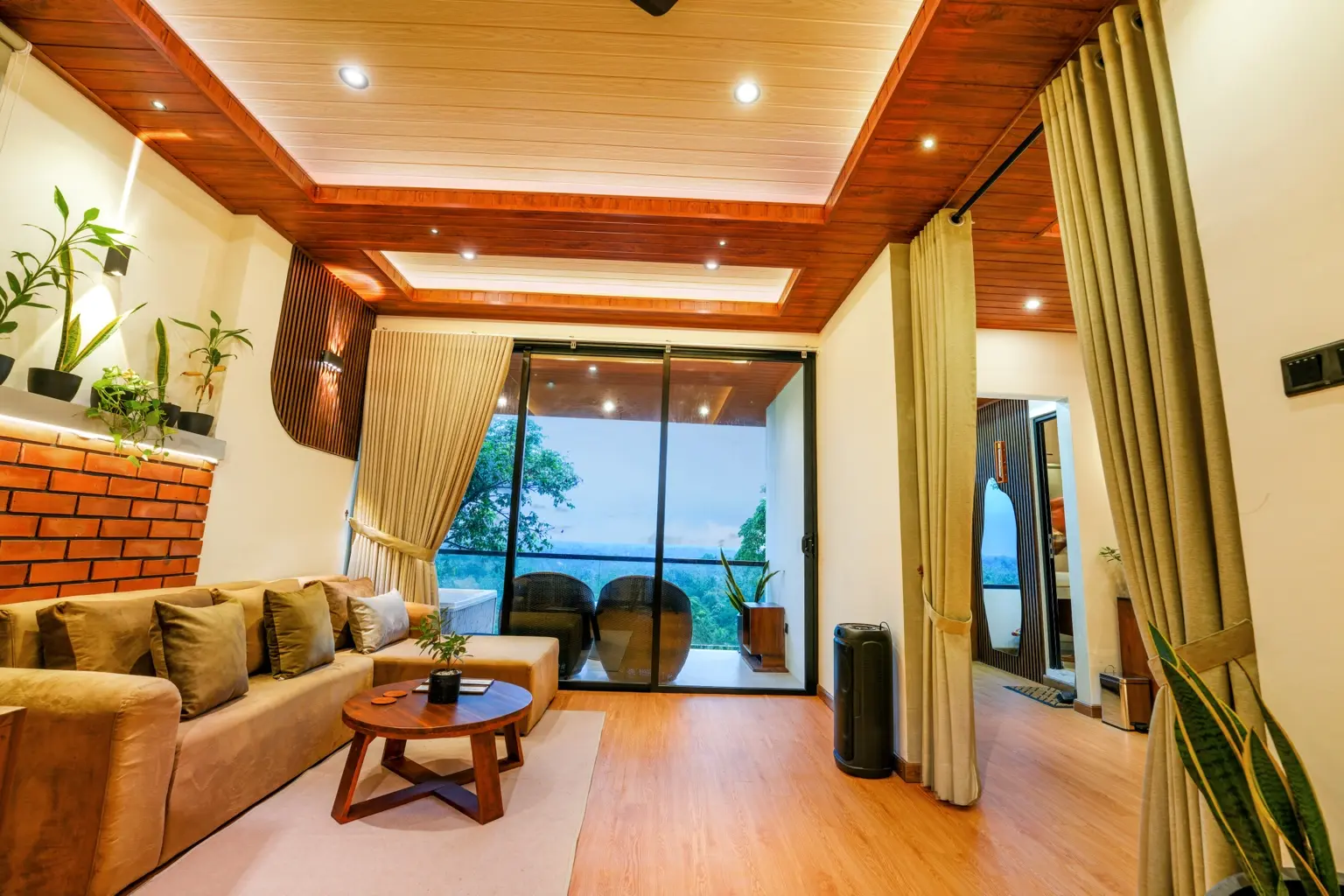 The private living room at Sivora Hills opening onto the balcony and green valley view